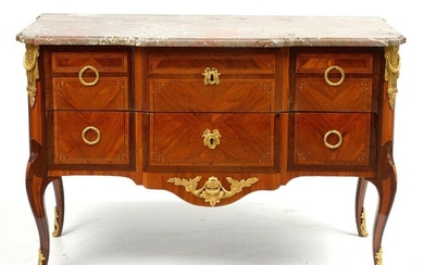 Transition style chest of drawers with a light central projection in mahogany veneer and light wood geometric marquetry opening by two drawers. Gilt bronze ornamentation and surmounted by a molded grey and reddish marble shelf. French work. Period:...