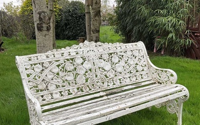 Victorian style white painted cast metal garden bench with lily pad and foliate design, 131cm wide.