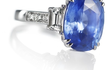 NOT SOLD. WIN: A Ceylon sapphire and diamond ring set with a natural Cornflower Blue...