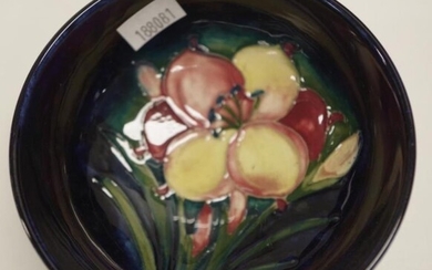 William Moorcroft blossom decorated bowl decorated on dark blue...