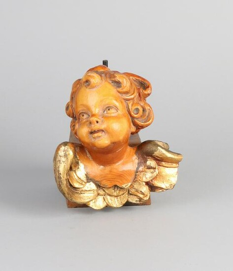 Wood carved, partly gilded cherub head with wooden
