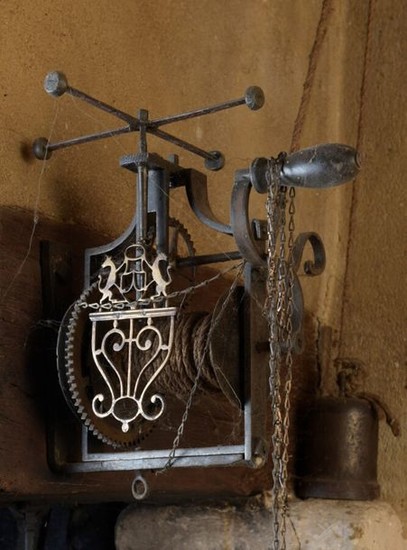 Wrought iron turn-spit decorated with a cut-out brass...