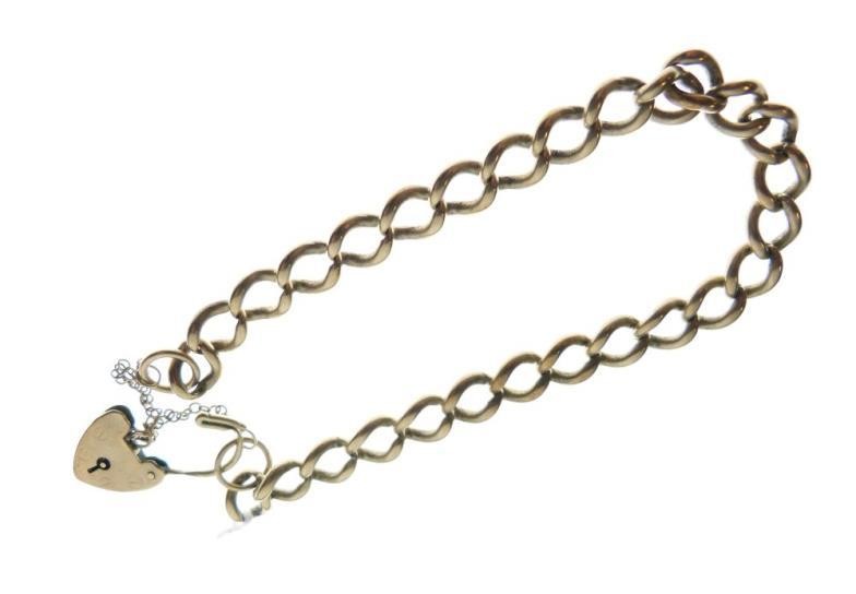 Yellow metal curb-link bracelet with heart-shaped padlock, indistinctly stamped,...