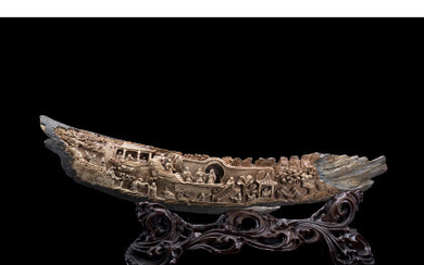 A section of a carved ivory tusk, wood base China, early 20th century (l. 52 cm.)