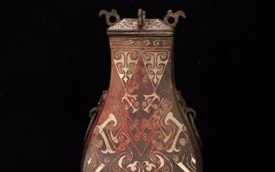 A COPPER JAR WITH ROOF