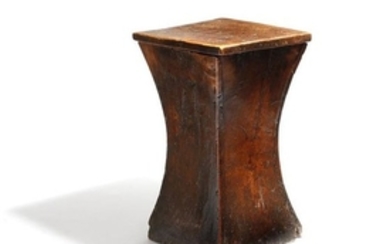 A George III elm box stool, of waisted shape, the …