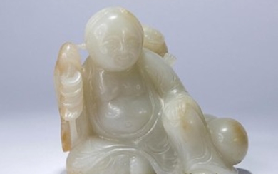 A WHITE JADE CARVING OF A BOY WITH TOAD