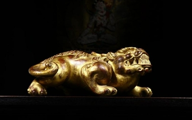 A WOOD CARVED LACQUER GOLD BEAST SHAPED PENDANT