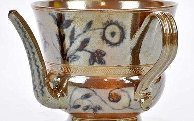 A 19th century salt glazed posset pot with high glazed...