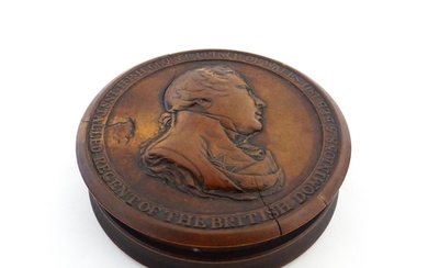 A 19thC treen snuff box of circular form the lid with a reli...