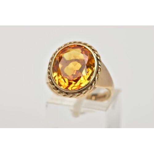 A 9CT GOLD SYNTHETIC ORANGE SAPPHIRE DRESS RING, designed wi...