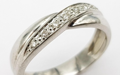 A 9K white Gold (tested) Diamond Twist Ring. 0.05ct diamond....