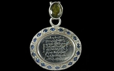 A CRYSTAL SILVER MOUNTED AND GEMSTONES- SET CARVED PENDANT, 4TH AH -10TH AD CENTURY