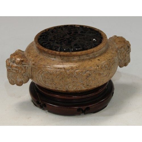 A Chinese brown soapstone ding censer, the sides carved in r...