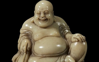 A Chinese carved soapstone figure of a seated Budai 寿山石雕布袋和尚
