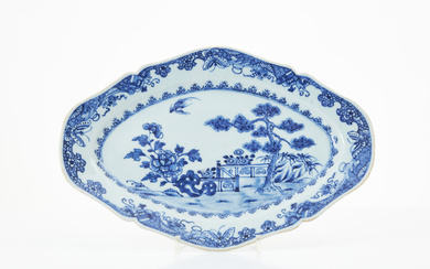 A Chinese porcelain dish, Qianlong (1736-1795), contoured brim, garden ledge centre decor with pine and peony in underglaze blue.