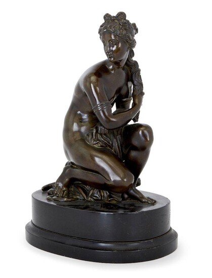 A French bronze model of the Crouching Venus, after the model by Antoine Coysevox (1640-1720), late 19th century, modelled resting on a turtle, above an oval black marble base, 40cm high overall Note: This cast is a 19th century reduction of...