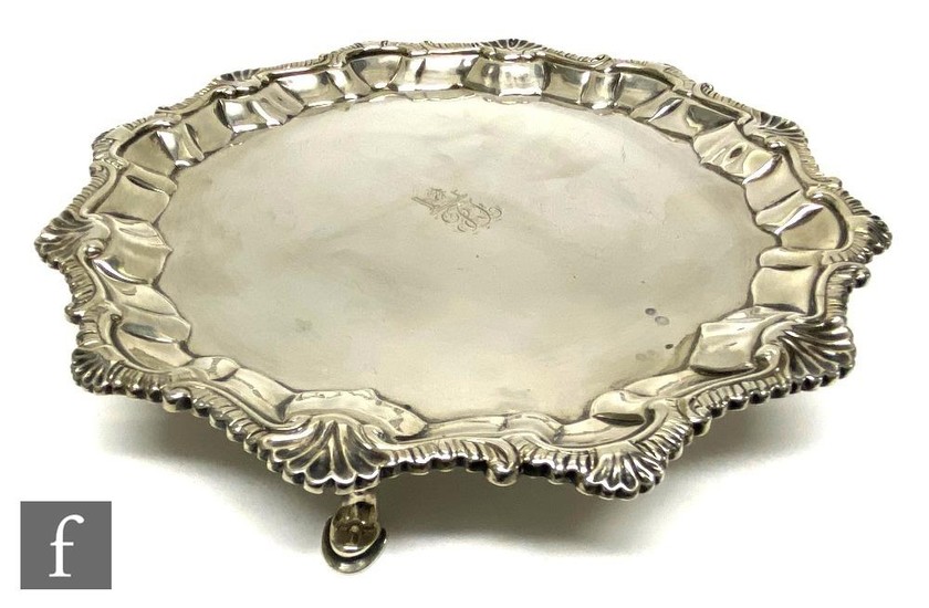 A George III hallmarked silver card waiter with engraved cen...