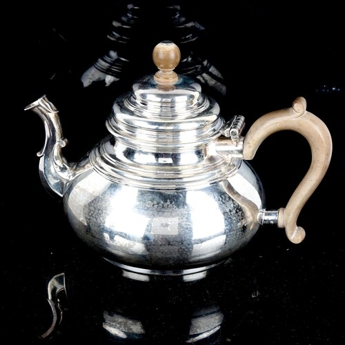 A George V silver squat teapot, in Queen Anne style, with sc...