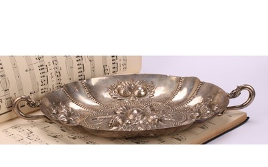 A German silver shaped oval fruit dish, chased in bold relie...
