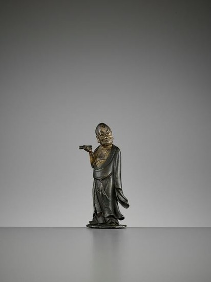 A LACQUER-GILT BRONZE FIGURE OF A LUOHAN, MING