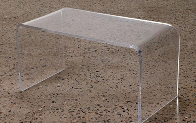 A LUCITE COFFEE TABLE OF CONTIUOUS DESIGN.