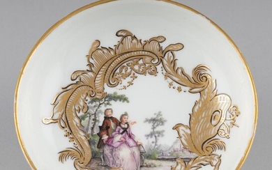 A Meissen porcelain saucer painted with a couple amongst trees, dia: 4 3/4 in. (12.07 cm.)