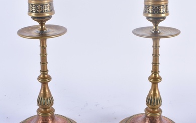 A PAIR OF ARTS AND CRAFTS BRONZE AND COPPER CANDLESTICKS dec...