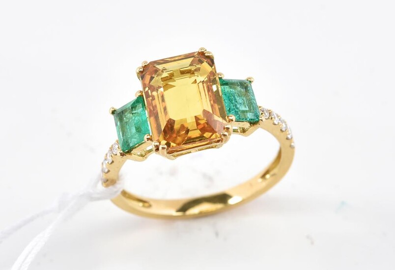 A SAPPHIRE, DIAMOND AND EMERALD RING - Featuring a yellow emerald cut sapphire weighing 3.83cts, shouldered by two rectangular emera...