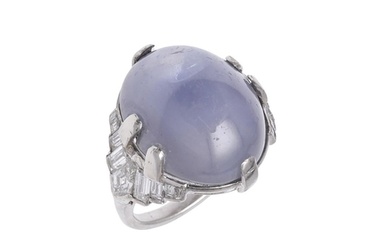 A STAR SAPPHIRE AND DIAMOND RING BY J.E. CALDWELL. the oval-...