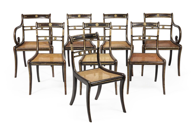 A Set of eight Regency ebonised and parcel gilt dining chairs
