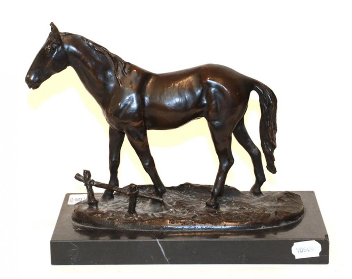 A bronze model of a horse on a black marble...