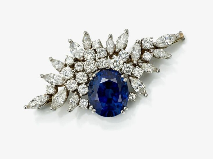 A brooch with royal blue sapphire and diamonds