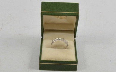 A diamond half eternity ring.