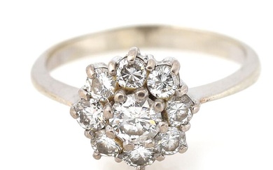 A diamond ring set with nine brilliant-cut diamonds, mounted in 18k whiter...