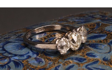 A diamond three stone ring, the central round brilliant cut ...