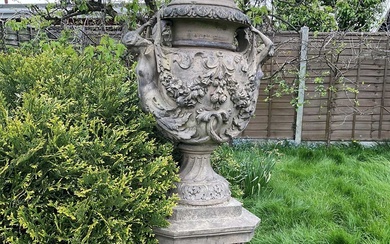A fine antique reconstituted stone garden urn and cover on plinth, with detachable lid, female caryatid handles, floral festoons on socle base, the plinth with figures and acanthus leaves, approxim...