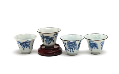 A group of blue and white porcelain teacups, each painted with horses