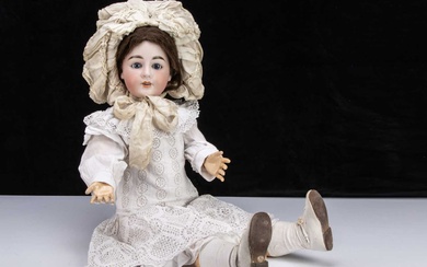A large German bisque headed doll embossed with I