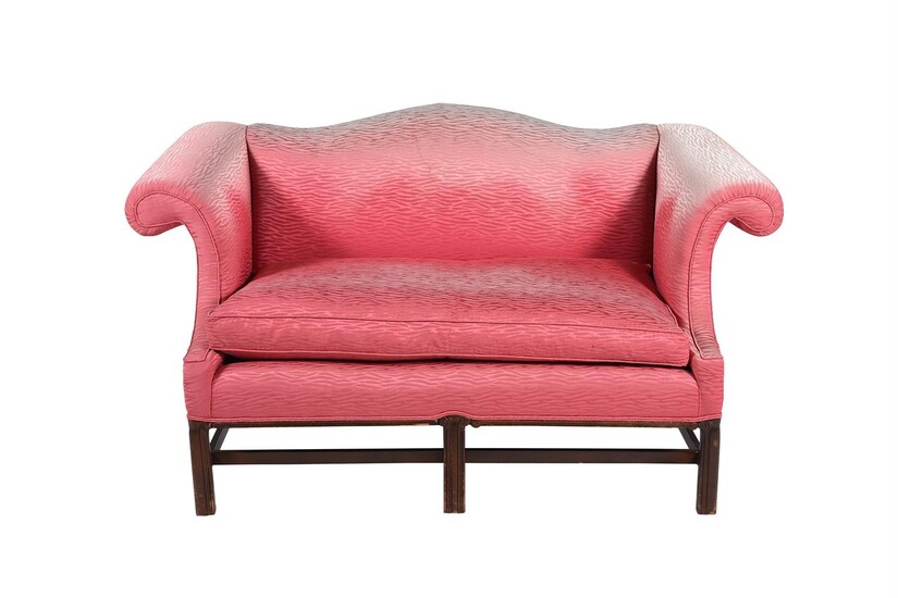 A mahogany and pink upholstered sofa in George III style