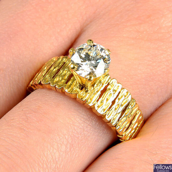 A mid 20th century 18ct gold brilliant-cut diamond single-stone ring, with textured half-band. Claw AF.
