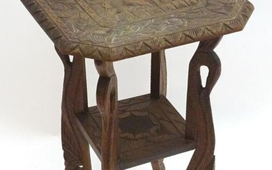 A mid 20thC oriental table with a carved octagonal top