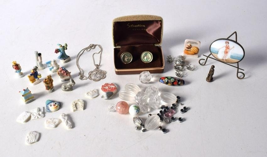 A miscellaneous collection of beads, rings, necklaces, small French ceramic fevres , etc. (Qty).