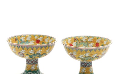 A pair of Chinese porcelain stem cups, decorated in enamel colours and...