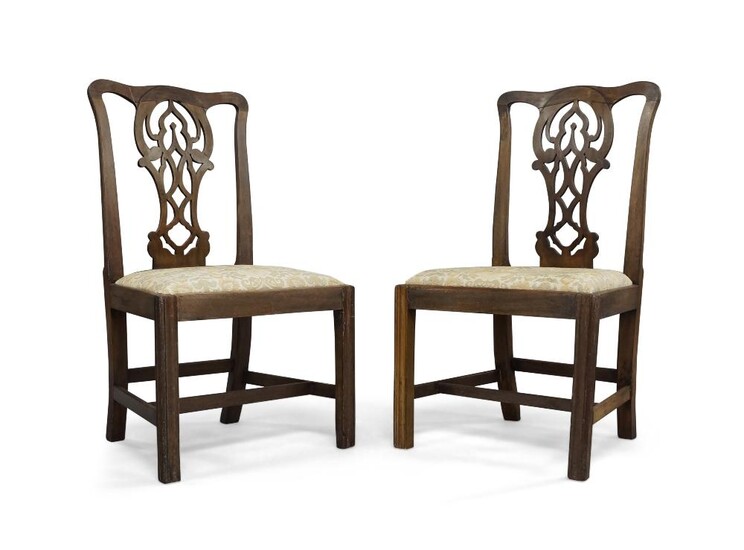 A pair of George III mahogany side chairs, in the manner of Chippendale, with pierced central splat above drop in seat on square front legs (2) Provenance: The Geoffrey and Fay Elliot collection.
