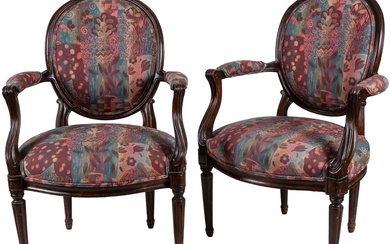 A pair of Louis XVI style oval carved armchairs...