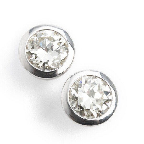 A pair of diamond ear studs each set with an old-cut diamond weighing a total of app. 4.00 ct., mounted in 18k white gold. (2)