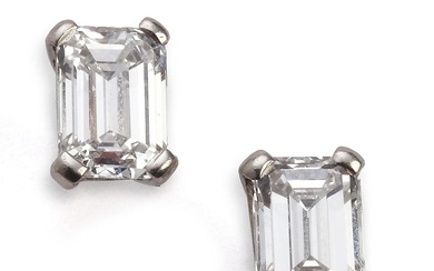 A pair of diamond ear studs each set with an...