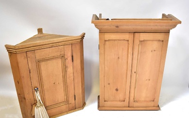 A pine corner wall-hanging cupboard with fielded and panelled door,...