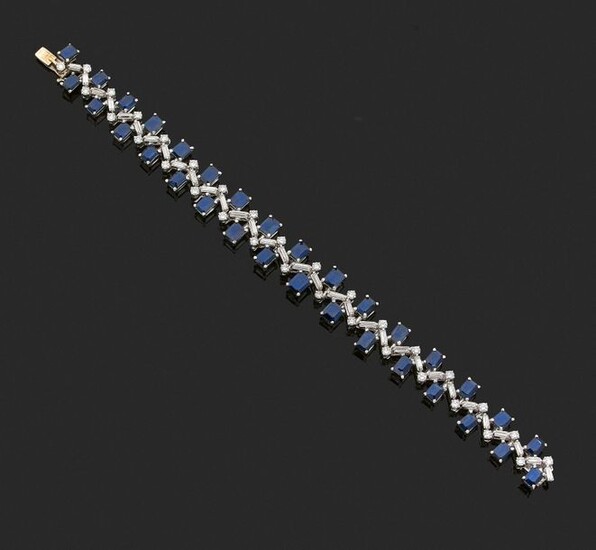 ARTICULATED BRACELET in 585 thousandths (14 kt) white gold, set with rectangular sapphires on either side of an animated line set with alternating baguette and round diamonds.